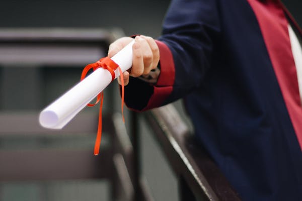 hand holding a diploma