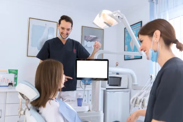 Dentist and assistant having a conversation with patient