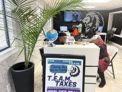 Two People sitting and having a conversation at T.E.A.M. FInancials Office