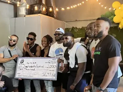 Group of people holding a giant check